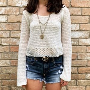 white  crotchet crop top with flared sleeves